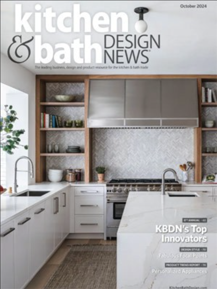 Modern kitchen with white countertops, stainless steel appliances, open wooden shelves, and a large range hood—an inspiring example of Luxury Interior Design featured on the cover of Kitchen & Bath Design News, October 2024 issue.