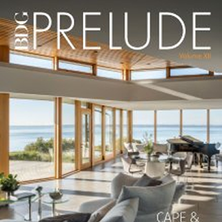 Magazine cover showcasing a modern, open living space with large windows overlooking the ocean, highlighting Luxury Interior Design. The title 