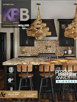 Modern kitchen with dark cabinets, patterned backsplash, wooden island with black stools, and geometric pendant lights. Featured in KBB magazine’s October 2020 cover on Luxury Interior Design by a top Interior Designer Massachusetts.