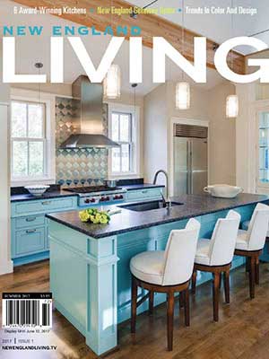 Cover of New England Living magazine featuring a modern kitchen with a turquoise island, three white chairs, stainless steel appliances, and pendant lighting—showcasing luxury interior design by a talented interior designer in Massachusetts.